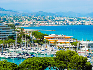 Landscape of the beautiful Marina Baie des Anges on against backdrop of Mediterranean Sea with yachts and sailboats. Villeneuve-Loubet. France. - obrazy, fototapety, plakaty