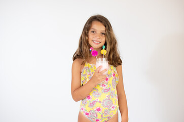 Beautiful girl in colorful swimsuit with a juice
