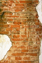 The ancient wall with red bricks, old flaky cracked paint. Ancient Ruins in the Arboretum Alexandria in Bila Tserkva. Concept of landscape and nature. Summer sunny day