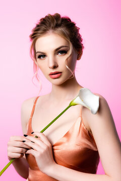 elegant beautiful blonde woman holding calla flower isolated on pink