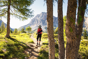 Fototapeta premium Adult hiker on the trekking trail in Dolomites, Passo Giau, Italy