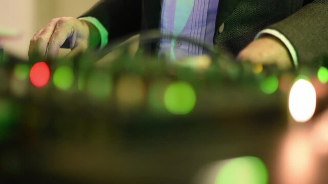 Dj dressed elegant at the mixer. Close up.