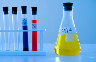 Covid-19 vaccine research. Test tubes and Erlenmeyer flask with colored liquids.
