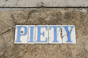 Traditional Piety Street Tile Inlay on Sidewalk in Bywater Neighborhood in New Orleans, Louisiana, USA