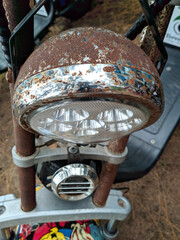 old and rusty electric bike headlights