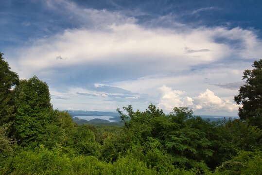 A mountain overlook with beautiful clouds and Lake Jocassee in South Carolina in the distance.