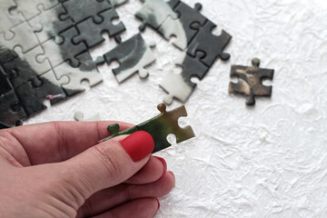 Puzzles in a woman's hand. Home educational games.