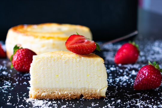 Cheese cake with strawberries on dark background