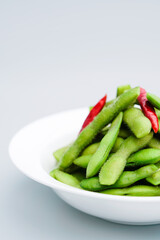A traditional Chinese delicacy in solid color, boiled soybeans in brine. Chinese traditional food boiled soybean.