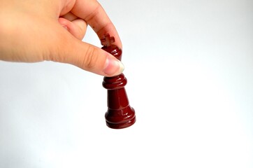 hand holds a chess piece