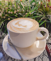 A cup of hot latte coffee with cream and fresh milk, beautiful patterns