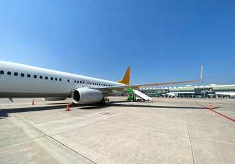 An unbranded airplane parked on the apron and waiting for the passenger, ready for boarding at the Izmir airport.