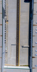 Aerial view of goods warehouse. Logistics center in industrial city zone from above. Aerial view of trucks loading at logistic center stock photo