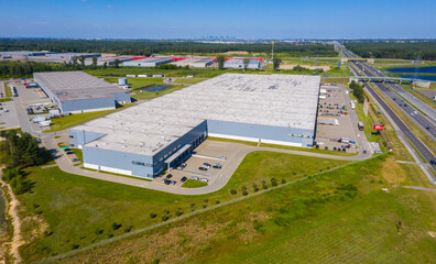 Aerial top view of the large logistics park with warehouse, loading hub with many semi-trailers...