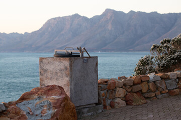Baboon safe waste bins next to public road in South Africa, Western Cape. Ocean view.