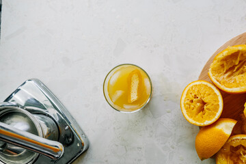 А glass of fresh orange juice from the juicer on the table the view from the top
