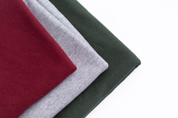 Angora fabric in three colors, fabric on a white background. three colors of fabric: Burgundy, gray, green