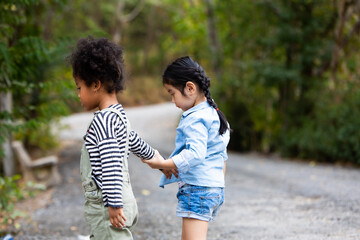 Children hiking in mountains or forest. Kids Camping summer. Two funny little girls having fun during forest hike on summer. Friend forever