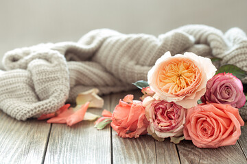 Cozy arrangement with roses on a wooden table