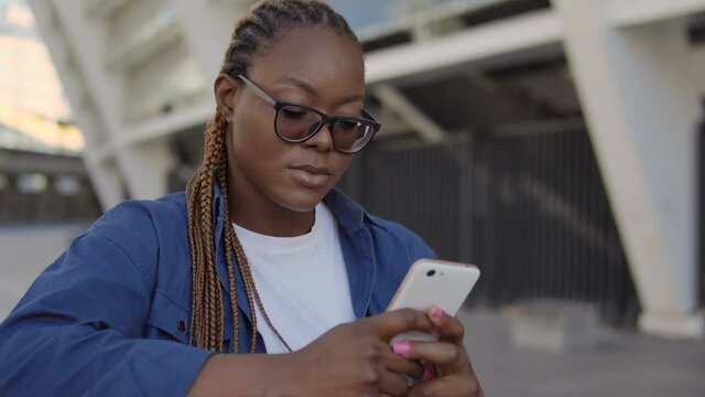 Pretty black woman chatting smartphone with boyfriend, couple conflict, break-up