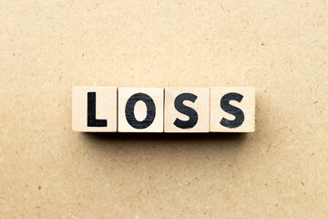 Letter block in word loss on wood background