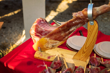 Jamon on the table outside, on red cloth