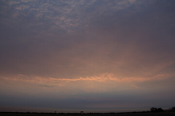 Fototapeta na wymiar Sunrise through the clouds