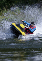 Riding on a water scooter.  Man on jet ski rides very close