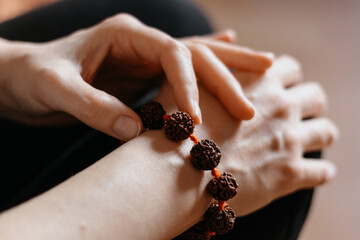 Rudraksha beads bracelet on Caucasian woman's hand, close up shot