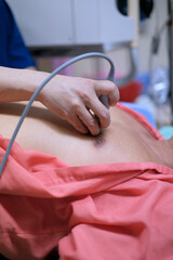 Physician making echocardiography for male patient heart by using ultrasound probe press on patient’s breast