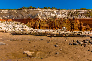 A shipwreck sits prominently in front of a chalk rockfall on Old Hunstanton Beach beneath the...