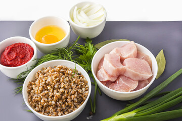 Recipe of cooking buckwheat cutlets or meatballs. Flat lay layout of Ingredients: buckwheat, turkey meat, onion and egg. Homemade food concept. Сopy space for text
