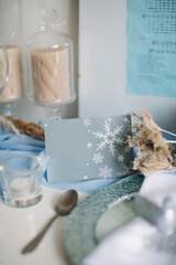 Table setting for Christmas and New Year in blue colors. Festive dinner. Postcard copy space.
