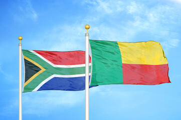South Africa and Benin two flags on flagpoles and blue sky