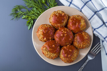 Recipe of cooking vegetarian buckwheat cutlets or meatballs. Cooked buckwheat meatballs with tomato sauce. Homemade food concept. Сlose up