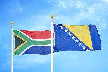 South Africa and Bosnia and Herzegovina two flags on flagpoles and blue sky