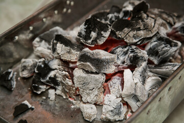 embers in a container for cooking barbecue