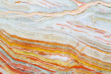 Fototapeta na wymiar Onyx texture background of natural stone with polished orange streaks. marble texture used for indoor and outdoor home decoration
