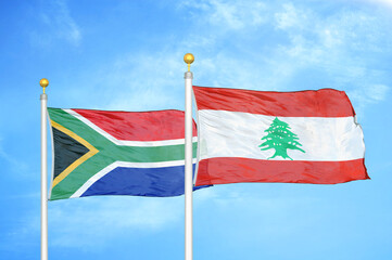 South Africa and Lebanon two flags on flagpoles and blue sky