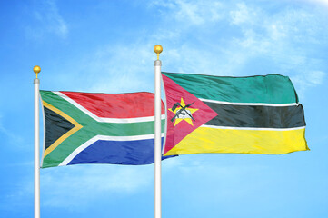 South Africa and Mozambique two flags on flagpoles and blue sky