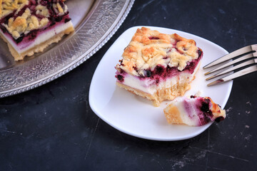 Homemade Blueberry Pie Bars. Delicious Crumble Bars on dark background.