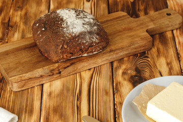 Rye bread on cutting board on wooden table