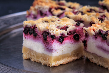 Homemade Blueberry Pie Bars. Delicious Crumble Bars on dark background.