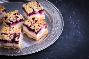 Homemade Blueberry Pie Bars. Delicious Crumble Bars on dark background.