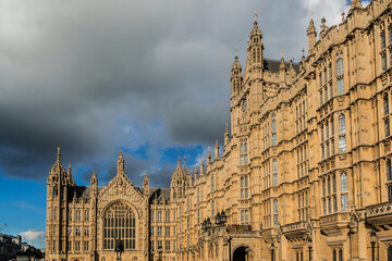 Fototapeta premium View of architectural details of Palace of Westminster (known as Houses of Parliament) located on north bank of River Thames in City of Westminster. London, England, UK.
