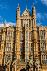 View of architectural details of Palace of Westminster (known as Houses of Parliament) located on north bank of River Thames in City of Westminster. London, England, UK.