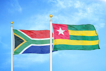 South Africa and Togo two flags on flagpoles and blue sky