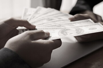 person of the businessman has a dollar note.