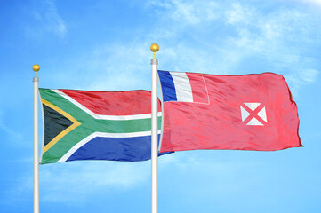 South Africa and Wallis and Futuna two flags on flagpoles and blue sky