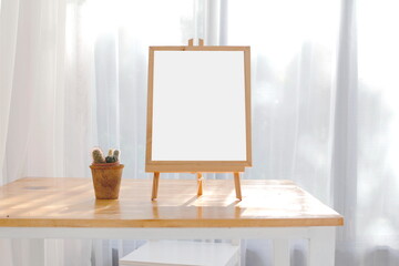 easel with blank canvas on the table